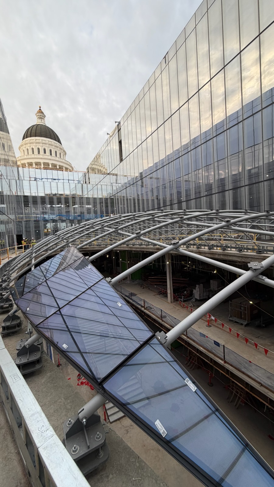 View of the new glass roof structure reflecting the historic Capitol Dome.