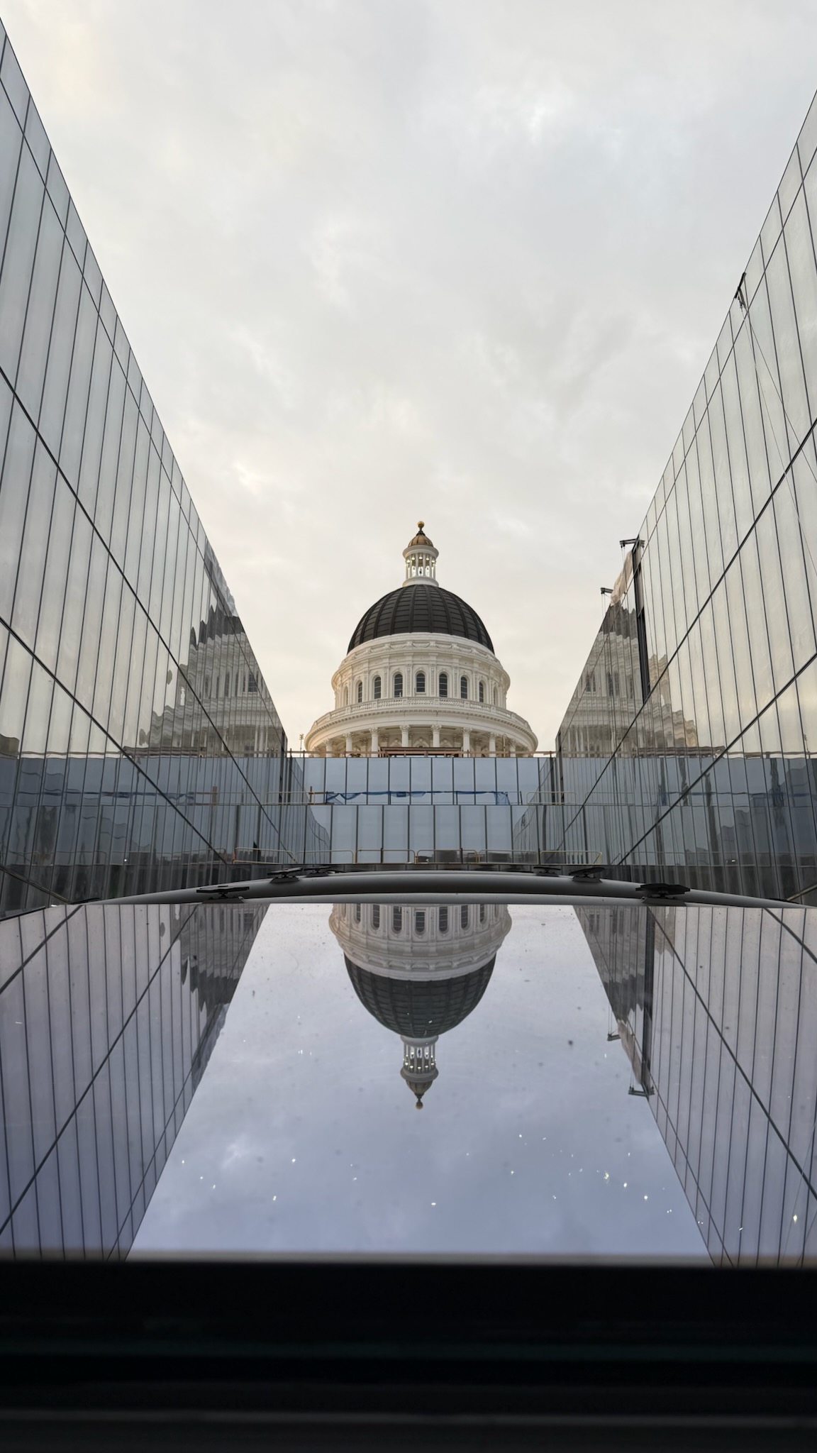 Low angle view looking between the new glass Annex walls towards the Capitol Dome.