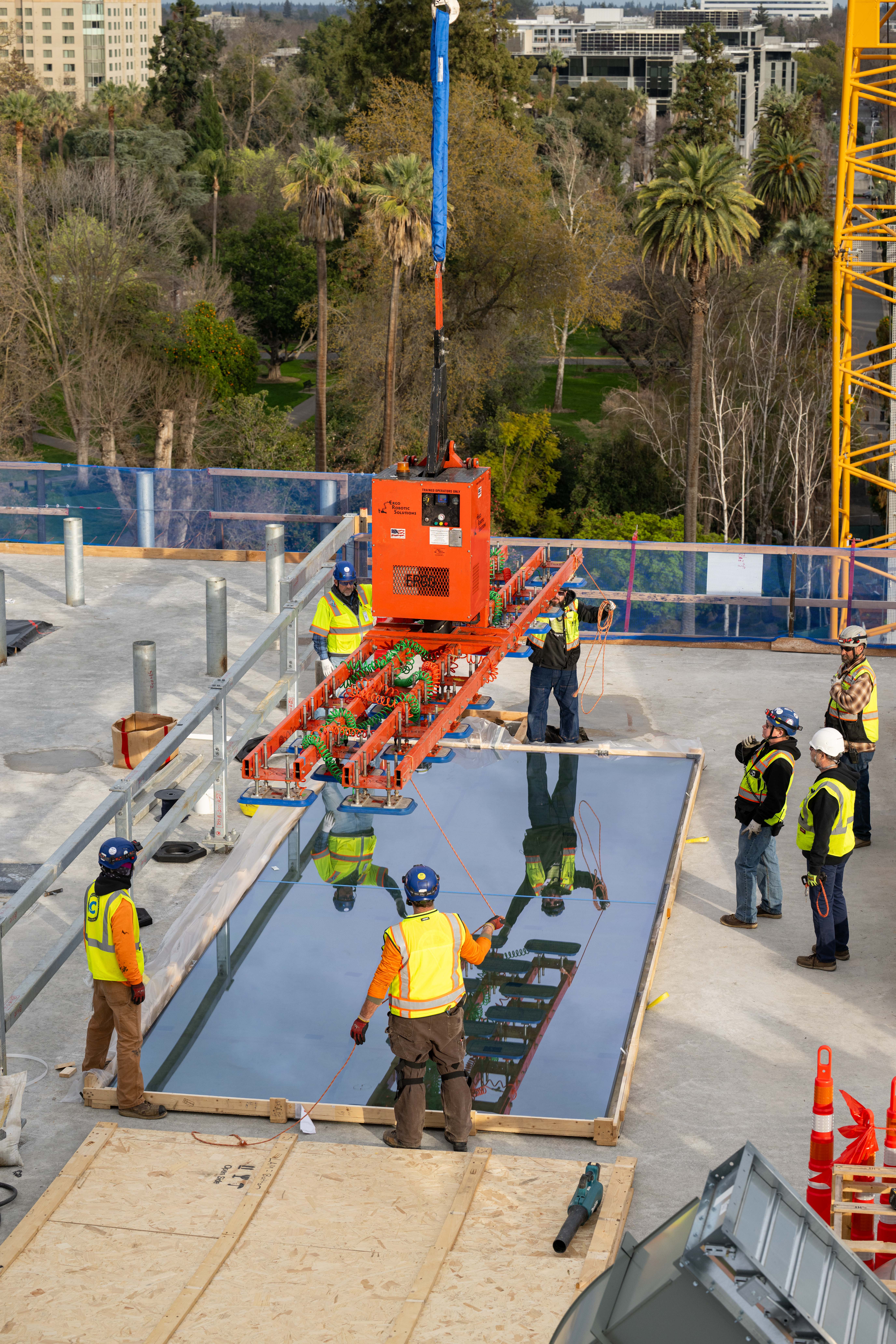 Workers install glass on the roof overlooking Capitol Park.