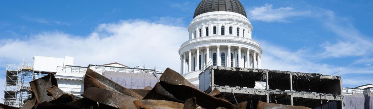 The Capitol dome visible behind the active construction site and building structure.