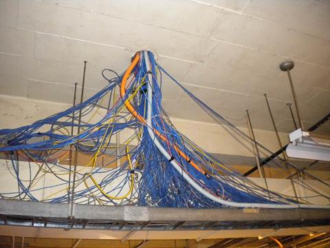 Undersized Electrical Infrastructure Large Tangle of Electrical Wiring coming from Duct